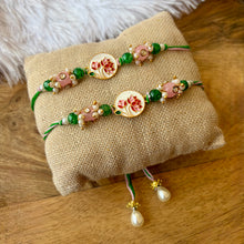 Load image into Gallery viewer, Stunning Pichhwai Lotus Braclet and Bhai Rakhi Pair
